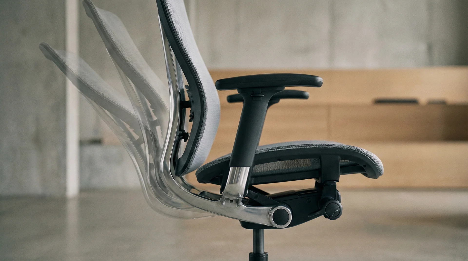 A side view of an ergonomic office chair demonstrating the synchro-tilt movement and reclining angles.